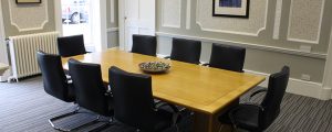 conference table with black chairs around it