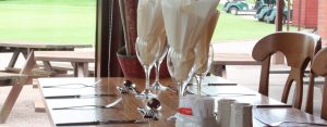 wine glasses with napkins on a table