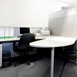 white desk with black chair in office