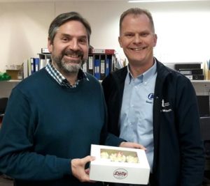 Sean McGrath giving cakes to a client