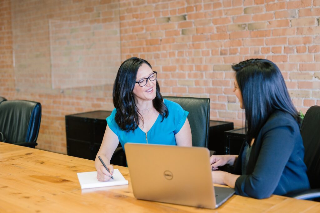 two corporate women at desk