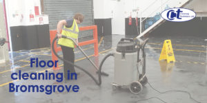 cleaner using floor scrubber on factory floor