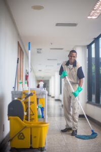 cleaner mopping floor in corridor